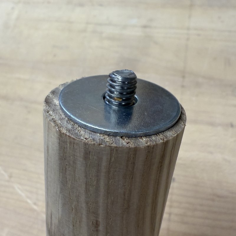 Put fender washer on leg before screwing it back in